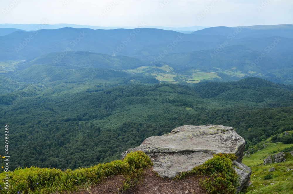 Carpathian Mountains. Panorama of green hills in summer mountains. Beautiful green mountain forest under blue sky. Carpathian Mountains. Panorama of green hills in summer mountains. Beautiful green mountain forest under blue sky.