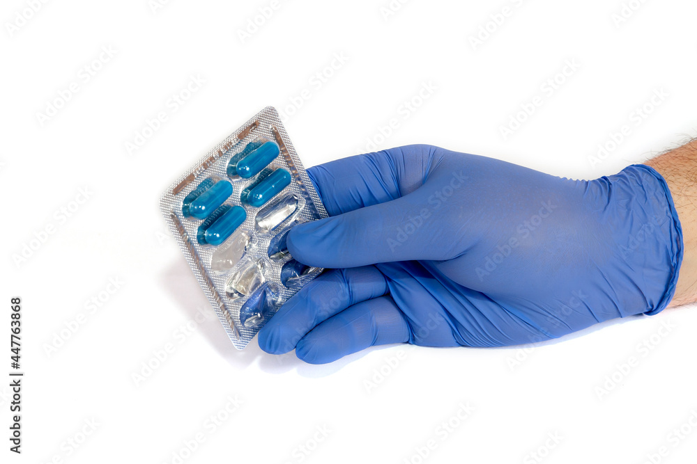 hand in a nitrile glove with blue stools hand in a nitrile glove with blue stools