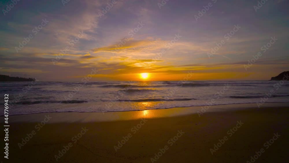 The scenery, beaches, natural beauty and wonders. sunset in the sea On a beautiful day, the sky is golden yellow and the sea waves wash on the beautiful soft sandy beach The scenery, beaches, natural beauty and wonders. sunset in the sea On a beautiful day, the sky is golden yellow and the sea waves wash on the beautiful soft sandy beach