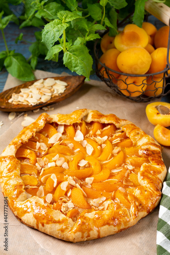 Wallpaper Mural French Galette or a pie with apricots and almonds on on a wooden serving board on a brown culinary background closeup. Summer homemade sweet pastries	 Torontodigital.ca