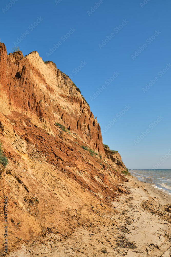 Beautiful landscape, sandy cliff over the sea.