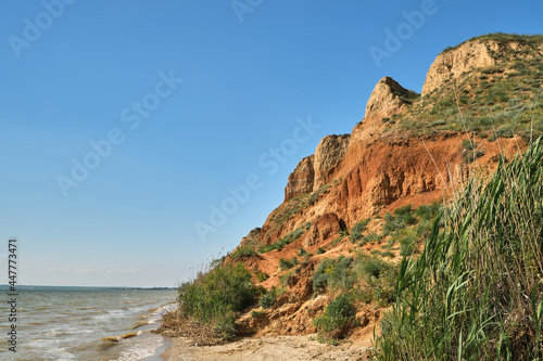 Beautiful landscape, sandy cliff over the sea.