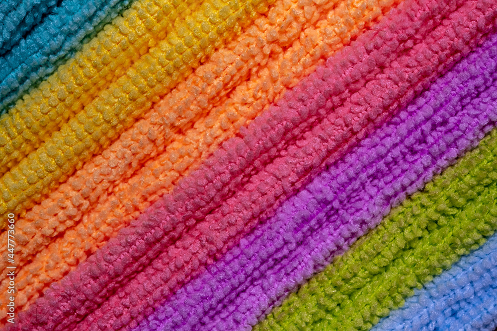 A stack of colored microfiber napkins. Row of diagonal colorful microfiber towels. Full frame