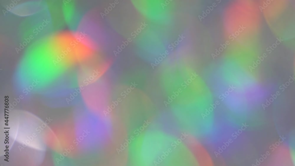 Rainbow Bokeh. Blurred holographic neon pink and purple lights. Holiday moving abstract background. Light and glare through a prism Rainbow Bokeh. Blurred holographic neon pink and purple lights. Holiday moving abstract background. Light and glare through a prism