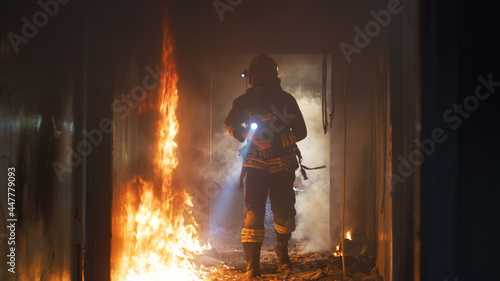 Fireman examining burning corridor during rescue mission