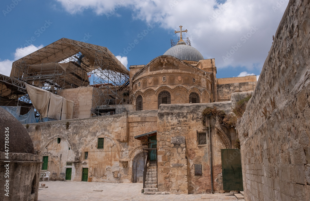 Back yard of Church of the Holy Sepulcher, Jerusalem Old City. Gray dome of the Church of the background. Church of the Holy Sepulcher under reconstruction.