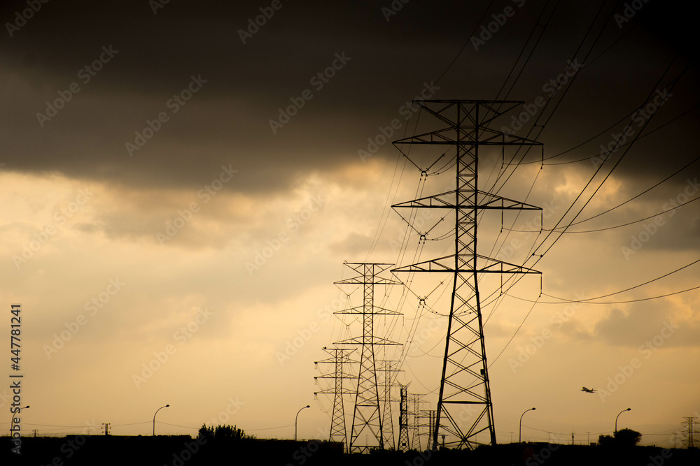 Power lines during sunset on a cloudy day