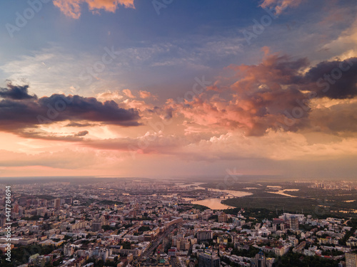 Aerial view on rain clouds at sunset over the city