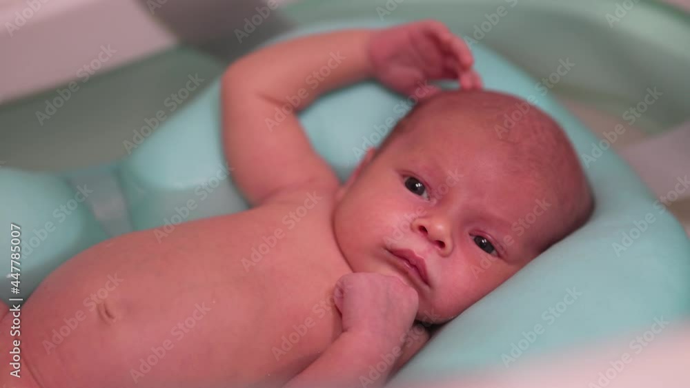 Little newborn baby having a bath. Newborn baby at bath time. Little newborn baby having a bath. Newborn baby at bath time.
