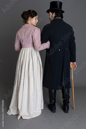 Regency couple against a grey studio backdrop