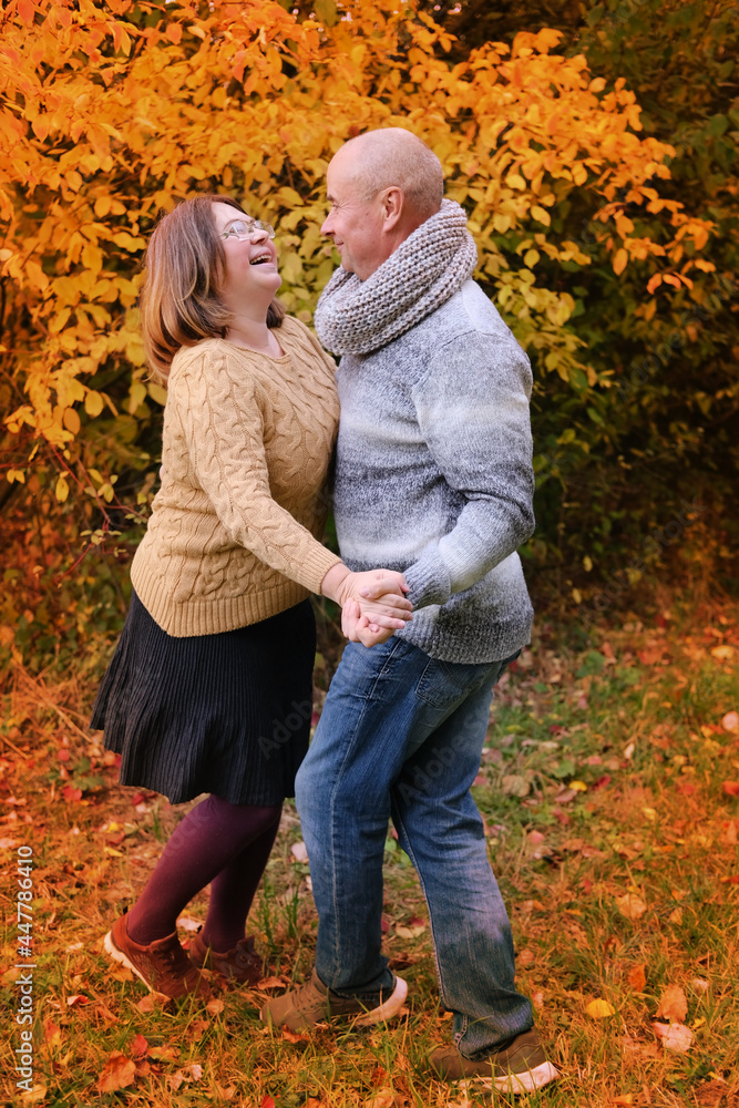 aged man and woman have fun dancing in the autumn park against the background of trees, the concept of a healthy lifestyle, good mood, happiness at any age aged man and woman have fun dancing in the autumn park against the background of trees, the concept of a healthy lifestyle, good mood, happiness at any age