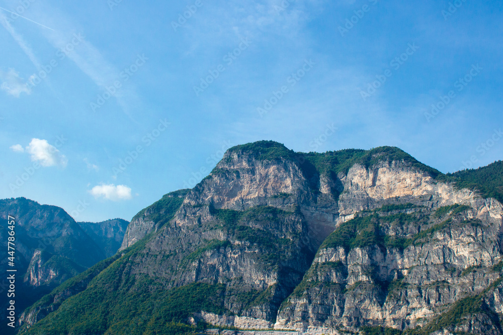 Mountain landscape in the alps in italy rising into the blue cloudless sky