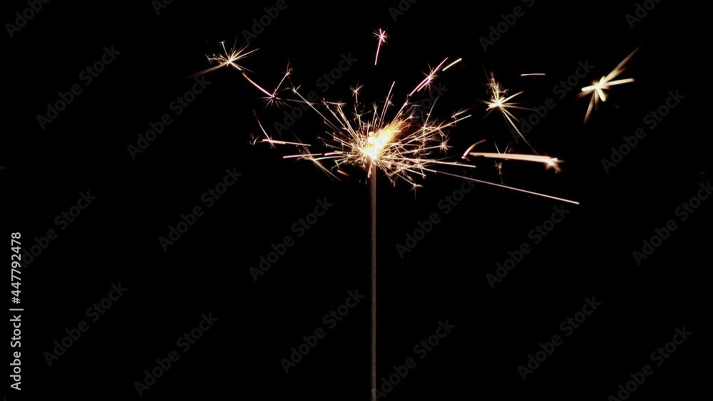Lightening Christmas sparkler on the black background. Christmas sparkler concept. Bengal lights are burning on a black background. Holiday party concept. Christmas and new year party sparkler. Lightening Christmas sparkler on the black background. Christmas sparkler concept. Bengal lights are burning on a black background. Holiday party concept. Christmas and new year party sparkler.