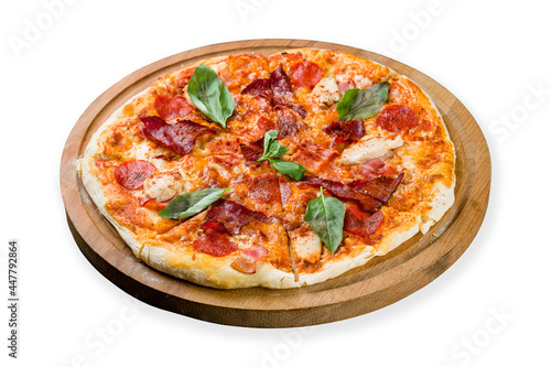 Italian meat pizza with chicken, ham, basil and cheese on the board isolated on white