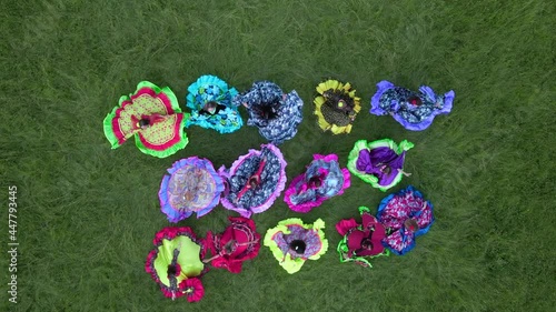 Many gypsy women in colorful dresses dancing, spinning and shake their hips slow motion
