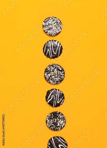 Chocolate cookies on yellow paper background. Minimal art. Holidays time, winter christmas celebration, diet, calorie, sweet shop concept. Flat lay wallpaper