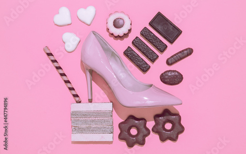 Chocolate candy cookies mix and lady heels shoes. Diet, addict, calorie, sweet lover concept. Flat lay minimal art