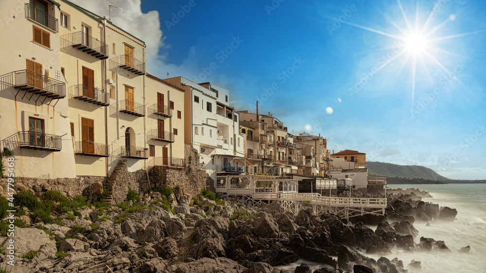 Old building on beach in Cefalu , Sicily, Italy.