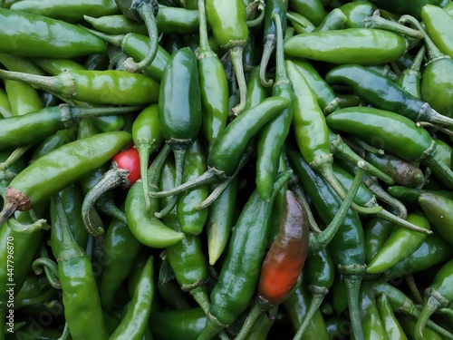 green and red chilis background closeup. 