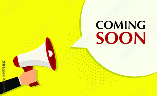 Coming soon yellow banner with hand holding megaphone. Vector illustration