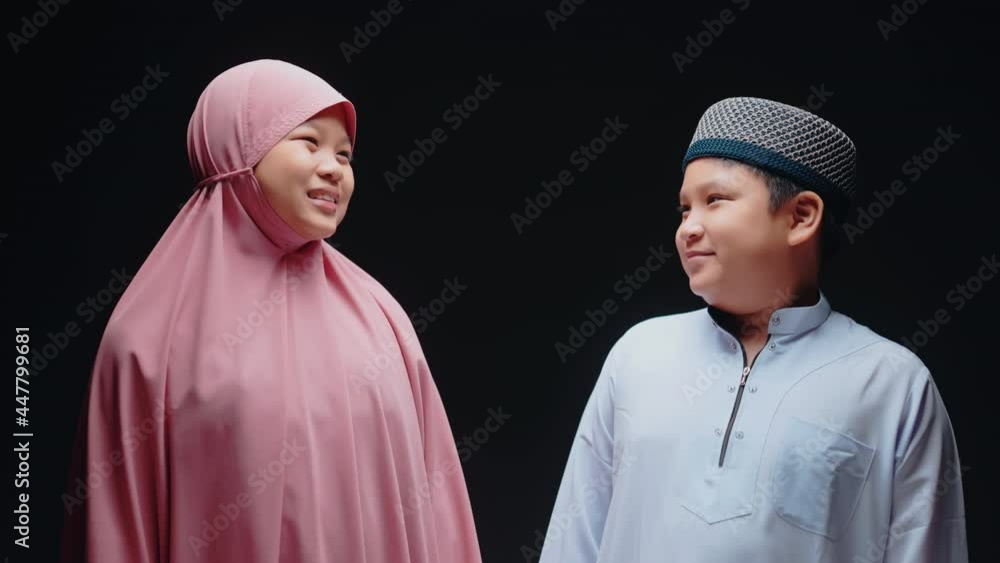 Concept Eid mubarak, Muslim girls and boys are Muslim, hug and greet in love at the mosque after prayer. Concept Eid mubarak, Muslim girls and boys are Muslim, hug and greet in love at the mosque after prayer.