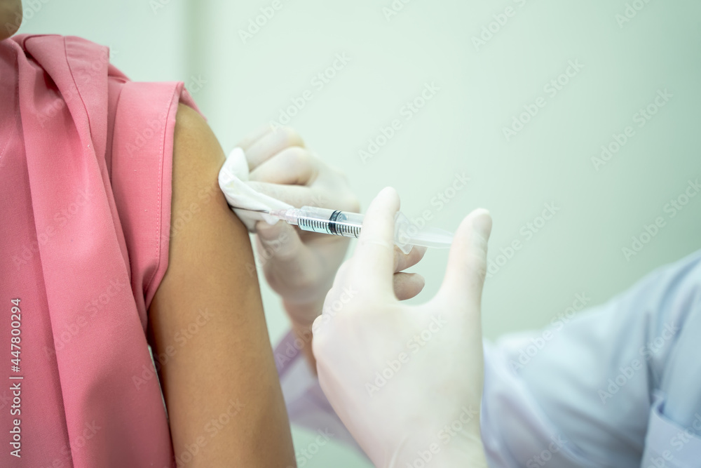 Closeup of doctor giving Covid-19,Medical personnel administers a vaccine to a patient,Medicine and health care concept. Closeup of doctor giving Covid-19,Medical personnel administers a vaccine to a patient,Medicine and health care concept.