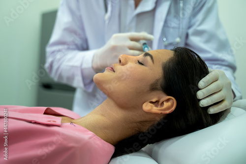 The doctor cosmetologist makes the Rejuvenating facial injections procedure for tightening and smoothing wrinkles on the face skin,Cosmetic medicine and surgery concept.