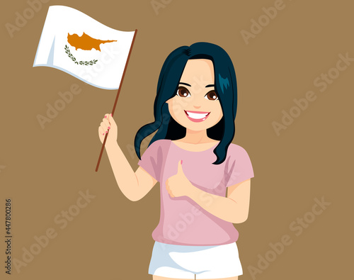 Young Cypriot woman holding...