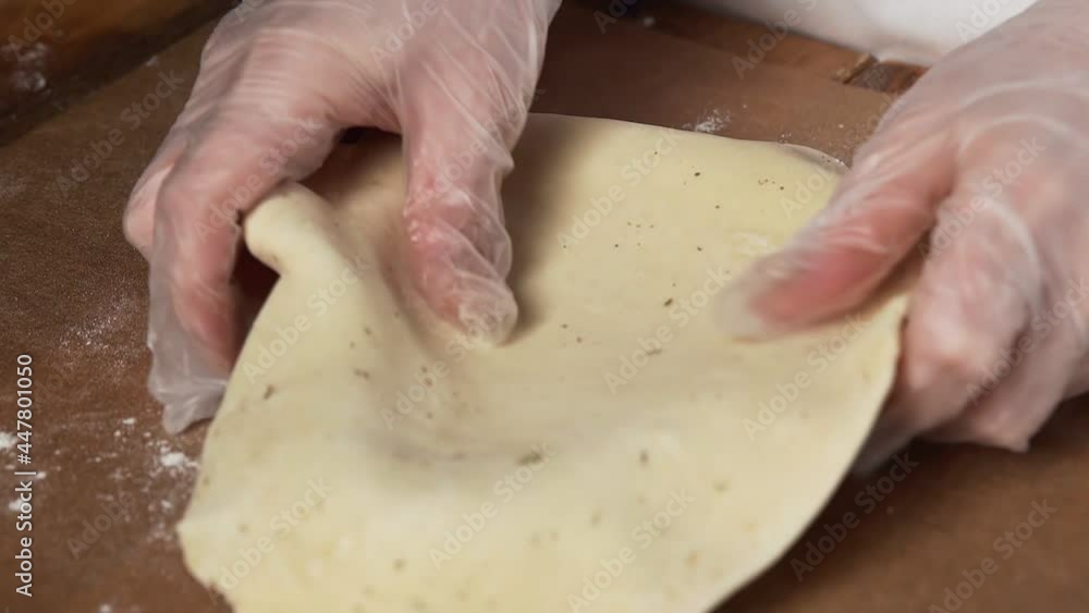 Professional chef puts dough in baking form to makes pie with broccoli, zucchini, salmon and cheese Professional chef puts dough in baking form to makes pie with broccoli, zucchini, salmon and cheese