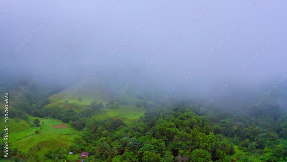 Aerial drone flight over green rainforest of Domincan Republic and flying clouds and fog in the air. Los Mogotes,Villa Altagracia. Aerial drone flight over green rainforest of Domincan Republic and flying clouds and fog in the air. Los Mogotes,Villa Altagracia.