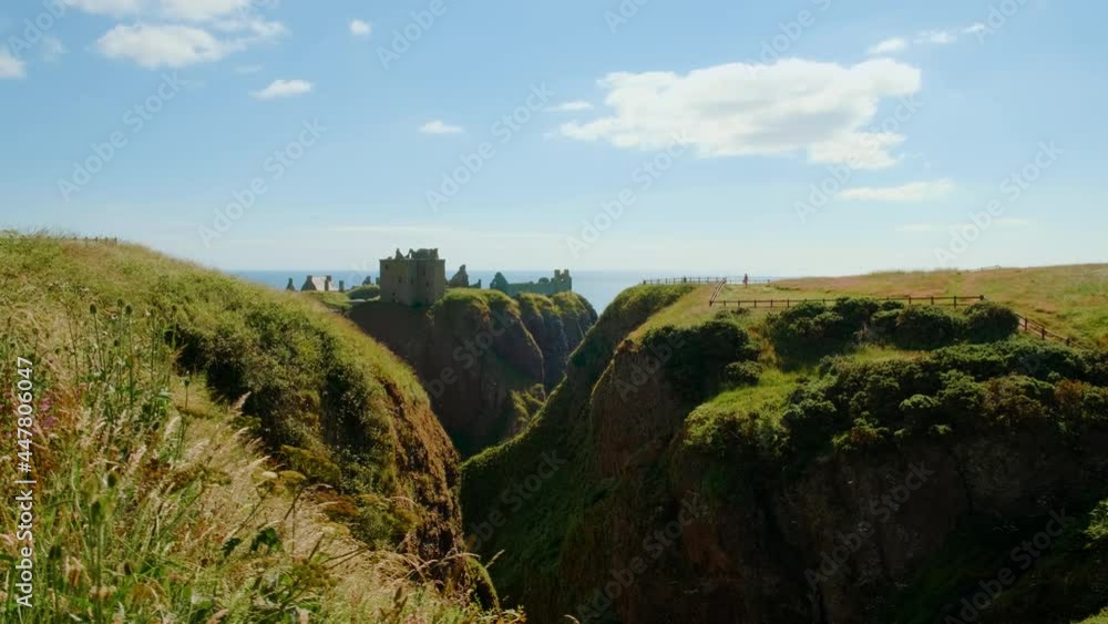 Cinematic view of the Dunnottar Castle, a medieval fortress on a rocky headland off the coast of Scotland, UK dating to 1400 Cinematic view of the Dunnottar Castle, a medieval fortress on a rocky headland off the coast of Scotland, UK dating to 1400