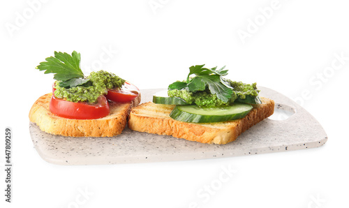 Tasty toasts with pesto sauce on white background