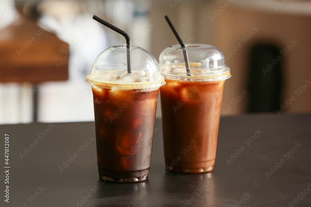 Plastic cups with tasty iced coffee on table Plastic cups with tasty iced coffee on table