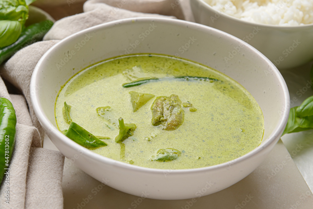 Bowl of tasty green chicken curry on light background, closeup Bowl of tasty green chicken curry on light background, closeup