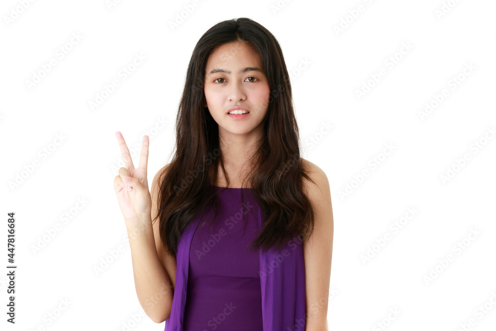 Serene ethnic female pointing up with index finger on white background in studio and looking at camera Serene ethnic female pointing up with index finger on white background in studio and looking at camera