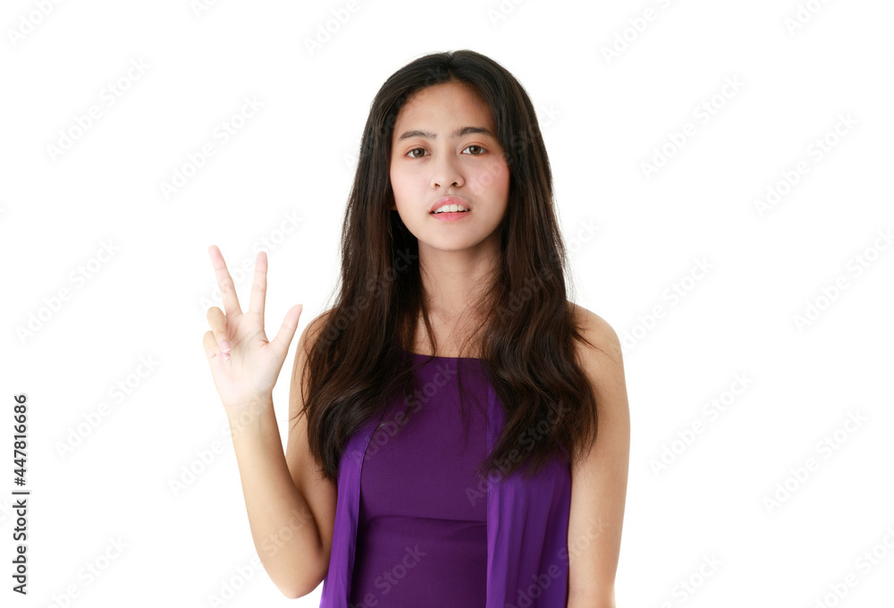 Serene ethnic female pointing up with index finger on white background in studio and looking at camera Serene ethnic female pointing up with index finger on white background in studio and looking at camera