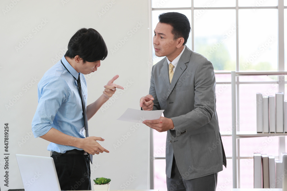 .Senior Asain businessman boss feel unhappy with serious face and argue with young junior employee. Daily problem from working in office concept .Senior Asain businessman boss feel unhappy with serious face and argue with young junior employee. Daily problem from working in office concept