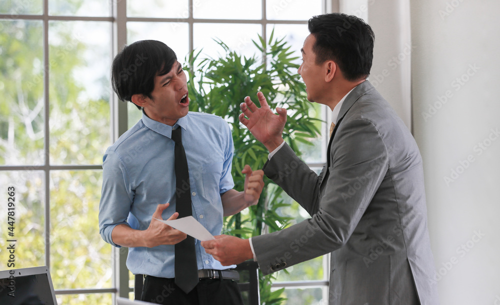Senior Asain businessman boss feels angry and unhappy with serious face and argue with young junior employee. Daily problem from working in office concept Senior Asain businessman boss feels angry and unhappy with serious face and argue with young junior employee. Daily problem from working in office concept