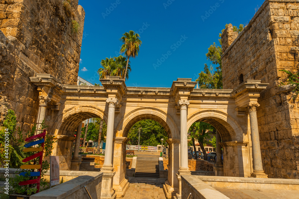 ANTALYA, TURKEY: Adrian Gate in the background blue sky. Antique ancient construction of marble and limestone.