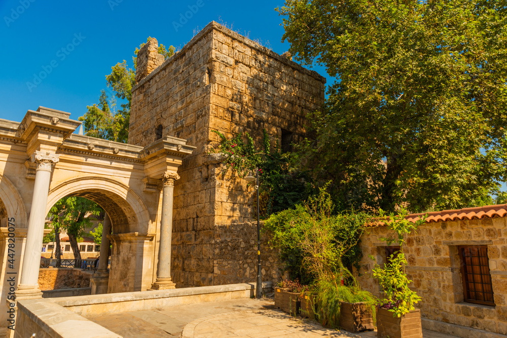 Obraz premium ANTALYA, TURKEY: Adrian Gate in the background blue sky. Antique ancient construction of marble and limestone.