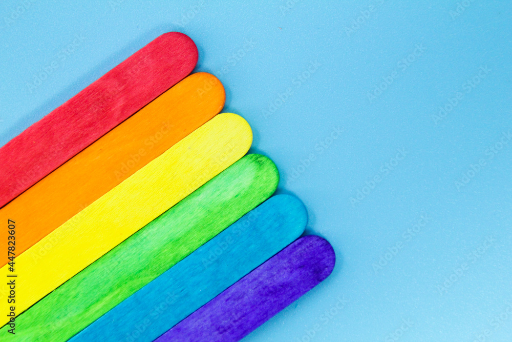 arrangement of ice cream sticks color with blue background arrangement of ice cream sticks color with blue background