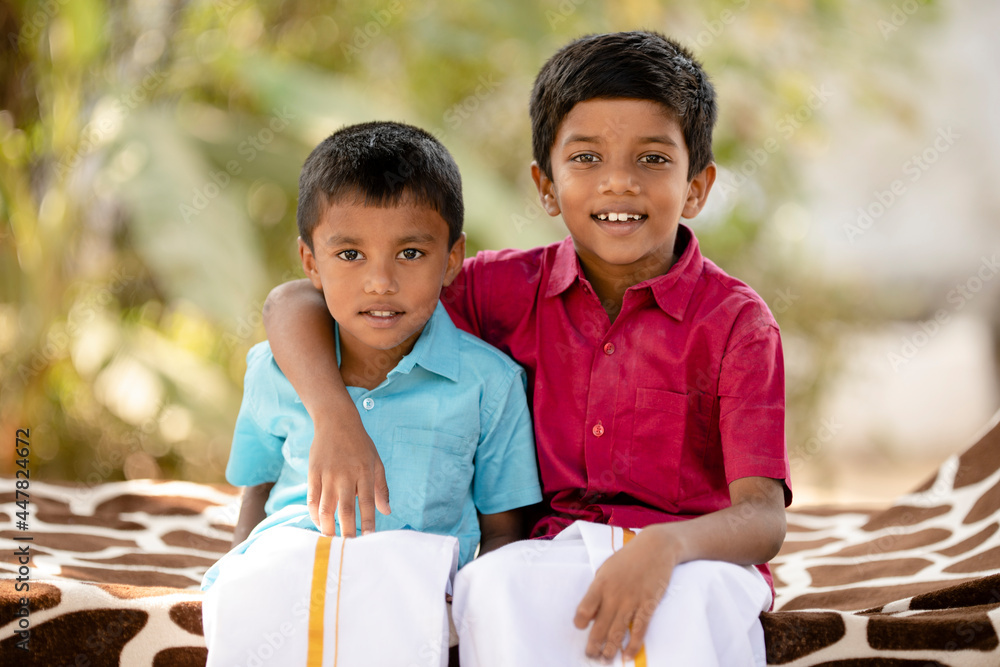 Cute Indian little brothers posing in traditional dress at outdoor