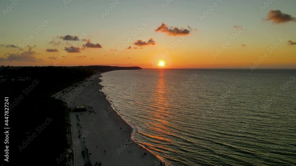 Baltic Sea and Wladyslawowo beach on Sunset, Poland. People walking along the sea enjoying coloful sky on sundown Baltic Sea and Wladyslawowo beach on Sunset, Poland. People walking along the sea enjoying coloful sky on sundown