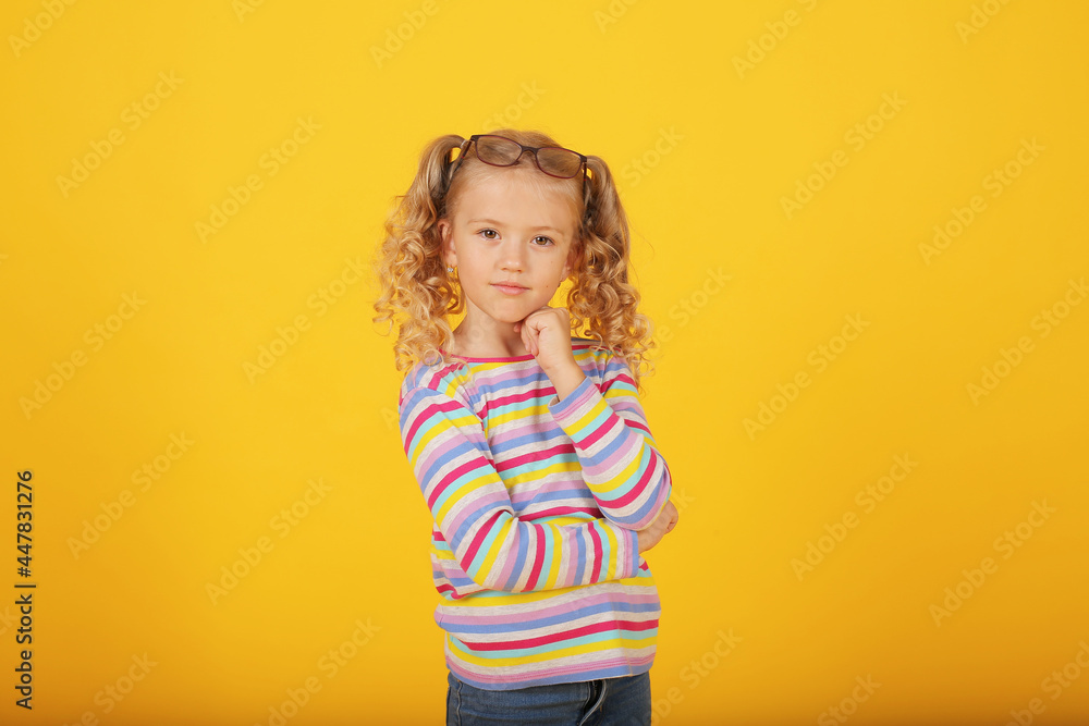 a beautiful blonde girl with ponytails and a multi-colored T-shirt shows emotions a beautiful blonde girl with ponytails and a multi-colored T-shirt shows emotions