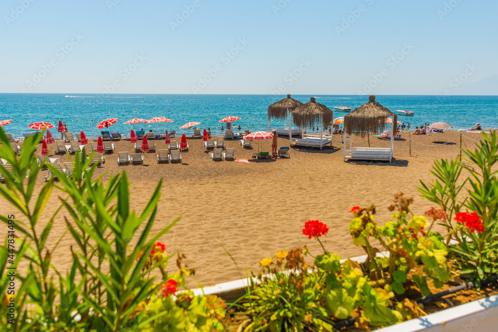 Fototapeta premium ANTALYA, TURKEY: Gazebos, sun loungers and umbrellas on the Lara beach on a sunny summer day in Antalya.