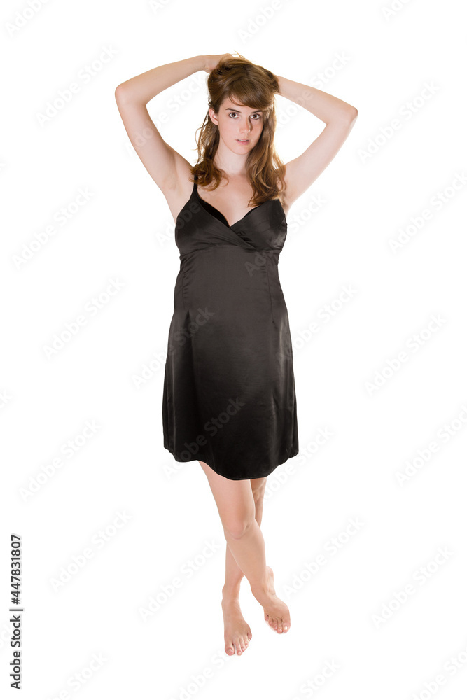 Full length portrait of a young woman wearing an elegant black evening dress, isolated in front of white studio background Full length portrait of a young woman wearing an elegant black evening dress, isolated in front of white studio background