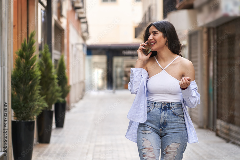 charming woman talking on mobile phone. Cheerful and smiling