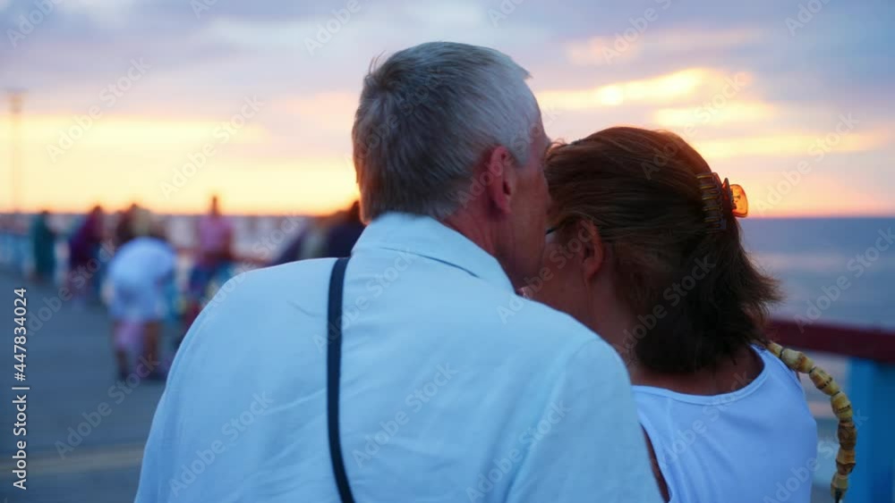 Sweet Old Couple Walking Along Palanga Bridge During Golden Hour In Lithuania. - Medium Shot Sweet Old Couple Walking Along Palanga Bridge During Golden Hour In Lithuania. - Medium Shot