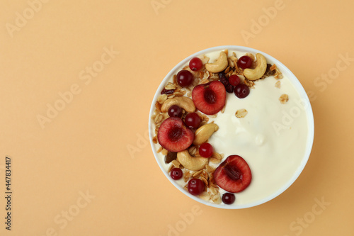 Concept of tasty breakfast with yogurt on beige background