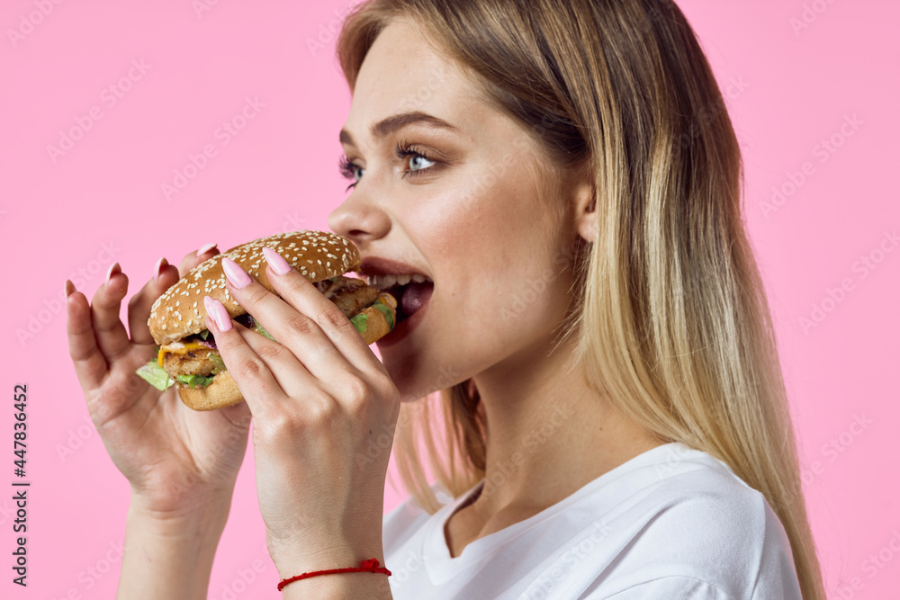 woman in white t-shirt hamburger snack delicious food restaurant woman in white t-shirt hamburger snack delicious food restaurant